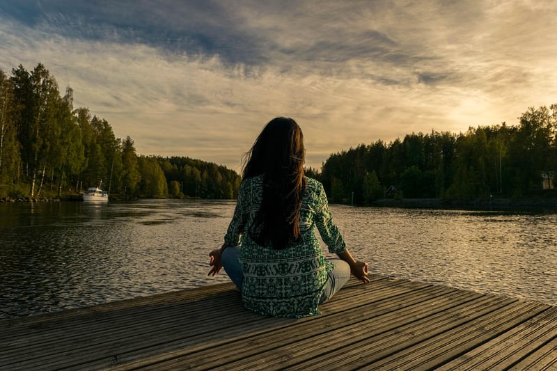 Woman meditating at sunset